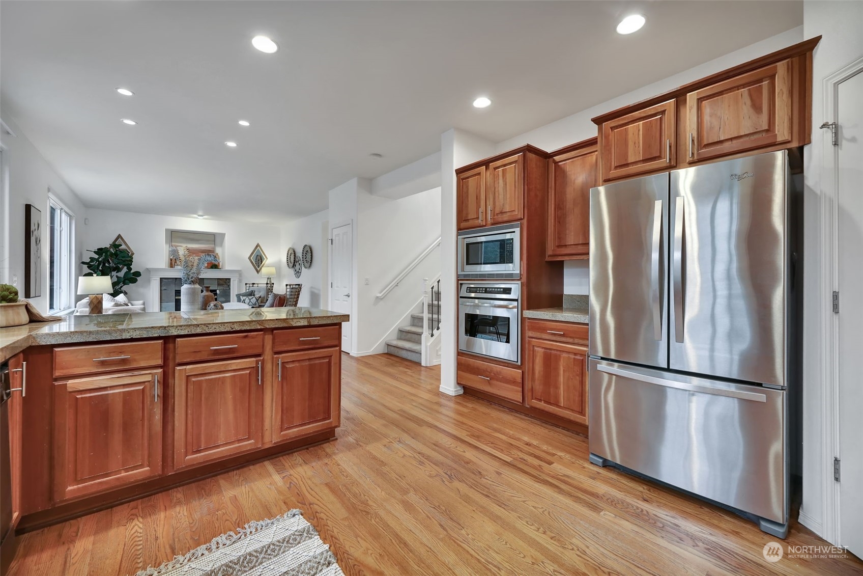 3714 Lincoln Court Northeast Renton, WA 98056 - Photo 11 of 33 a kitchen with stainless steel appliances granite countertop a refrigerator microwave and wooden floor