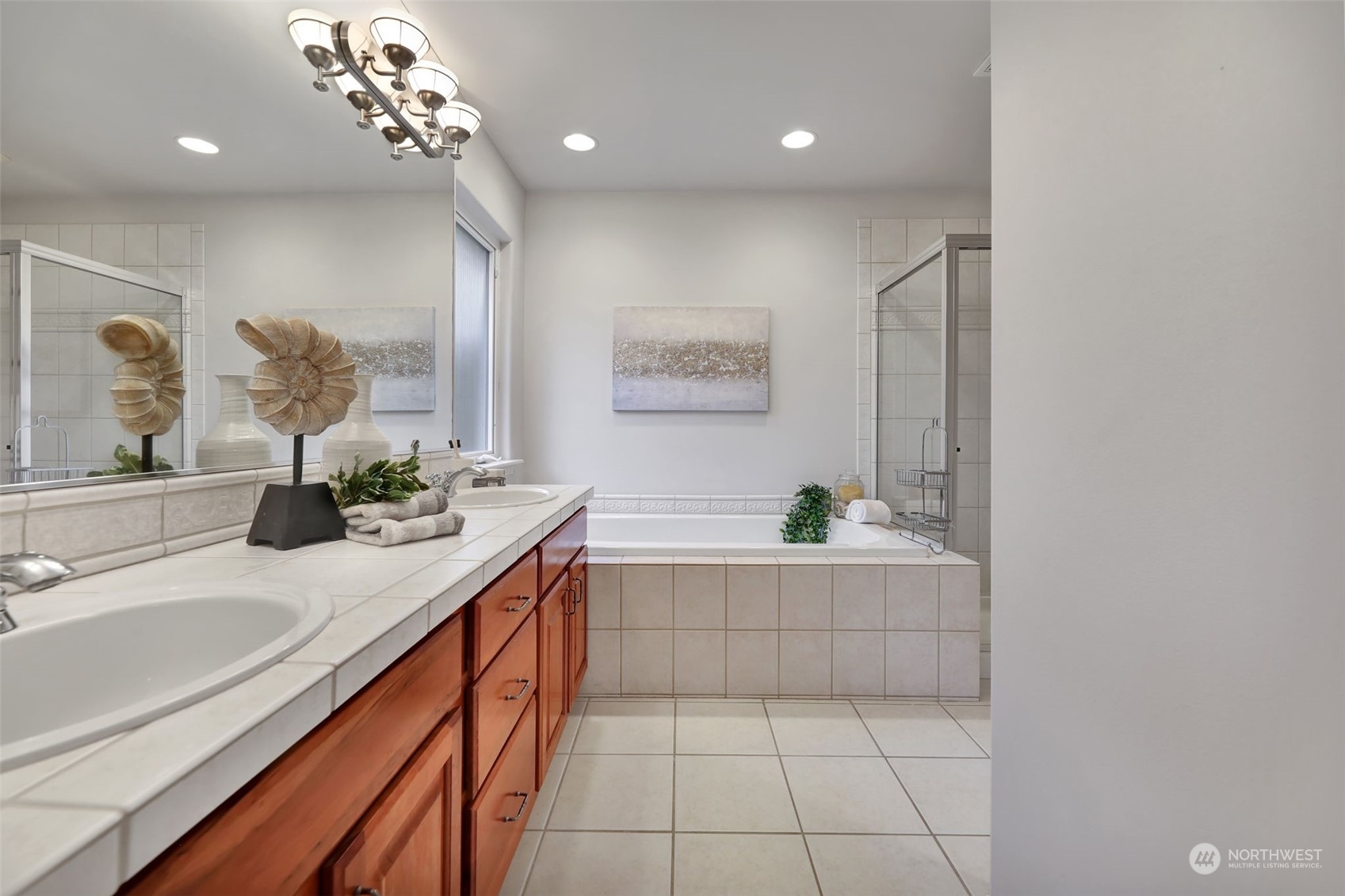 3714 Lincoln Court Northeast Renton, WA 98056 - Photo 17 of 33 a bathroom with a sink a large mirror and a bathtub