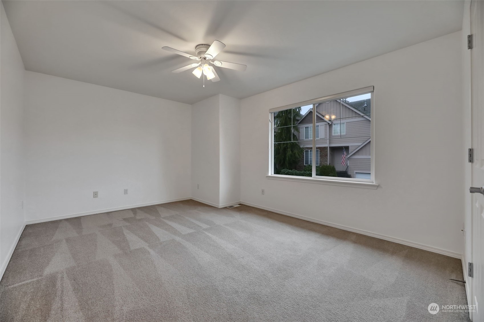 3714 Lincoln Court Northeast Renton, WA 98056 - Photo 22 of 33 a view of an empty room with chandelier fan and fire place