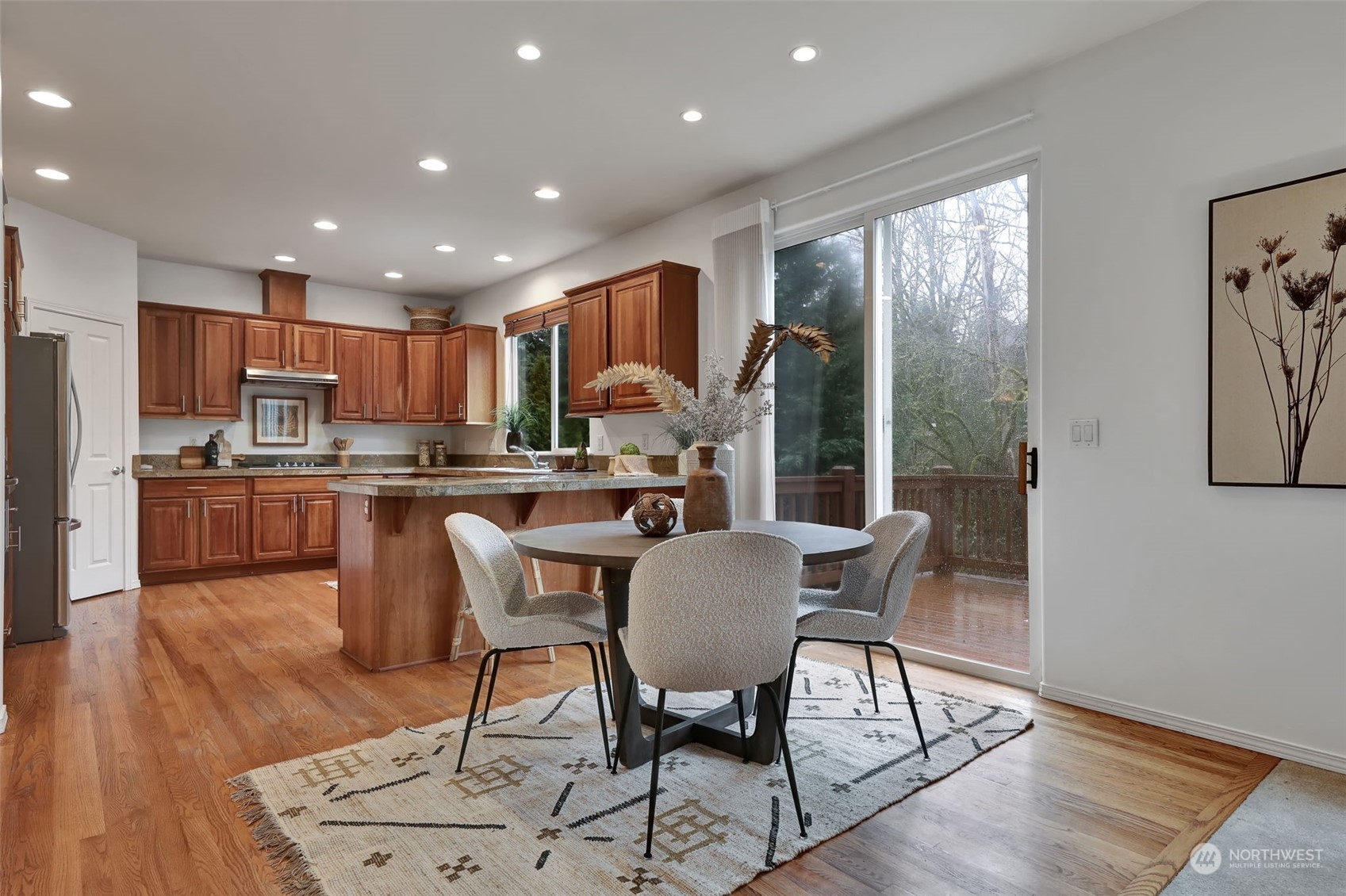 3714 Lincoln Court Northeast Renton, WA 98056 - Photo 8 of 33 a living room with stainless steel appliances furniture wooden floor and a kitchen view