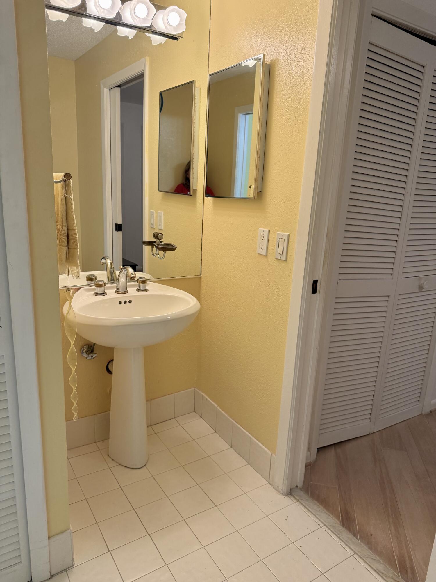 7024 Golf Pointe Circle Tamarac, FL 33321 - Photo 14 of 28 a bathroom with a sink a mirror and shower