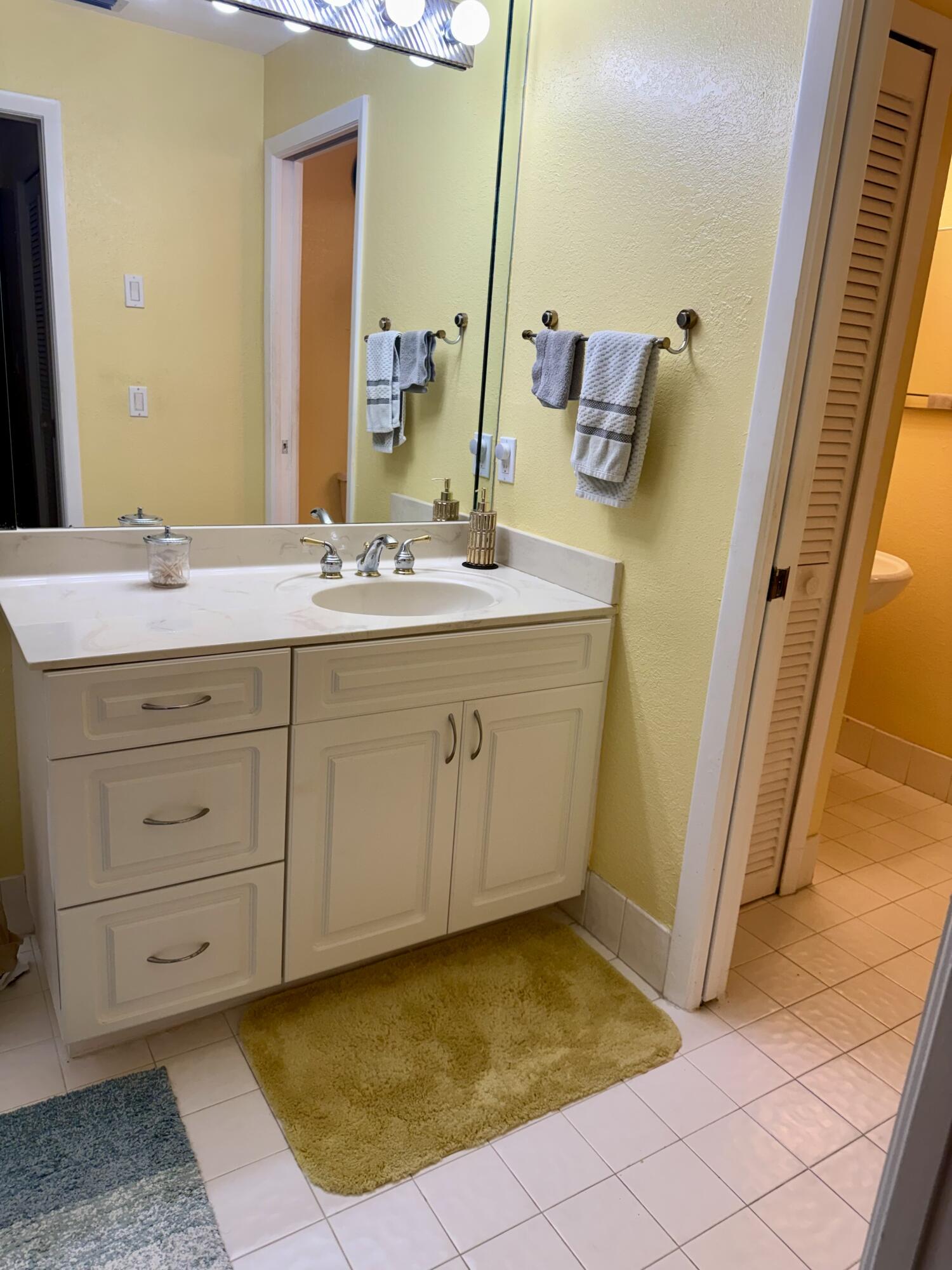 7024 Golf Pointe Circle Tamarac, FL 33321 - Photo 16 of 28 a bathroom with a sink and a mirror