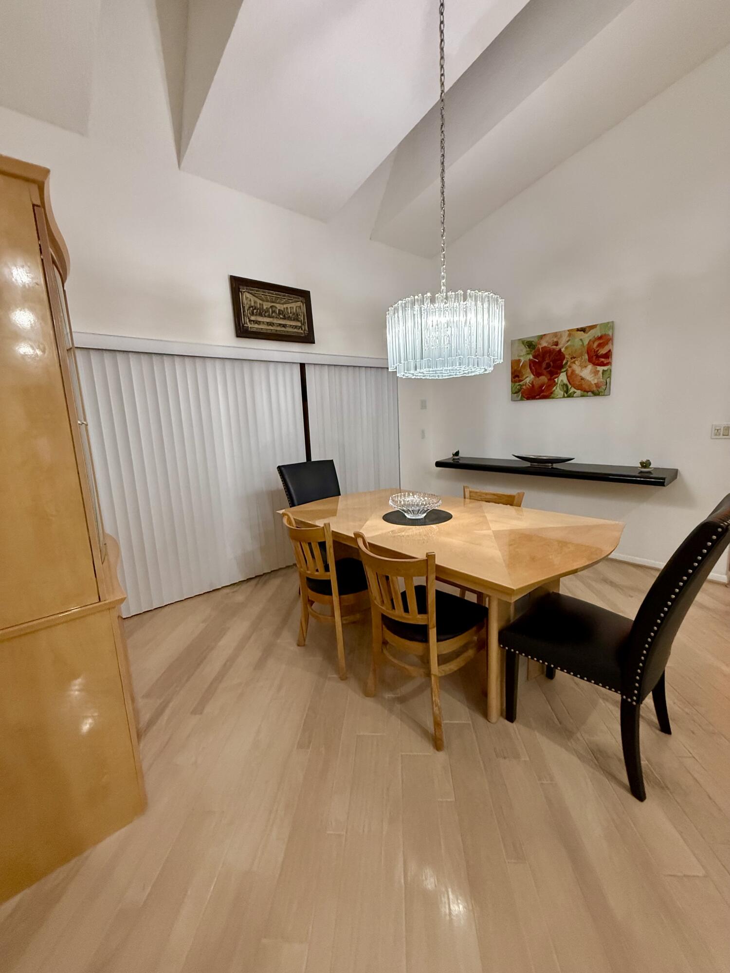 7024 Golf Pointe Circle Tamarac, FL 33321 - Photo 8 of 28 a view of a dining room with furniture and chandelier