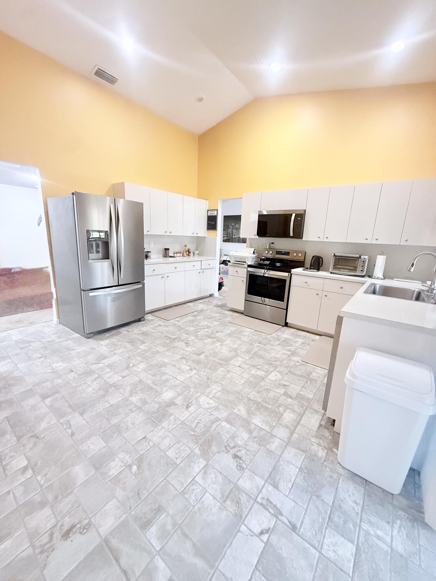 7024 Golf Pointe Circle Tamarac, FL 33321 - Photo 9 of 28 a living room with a couch and a coffee table