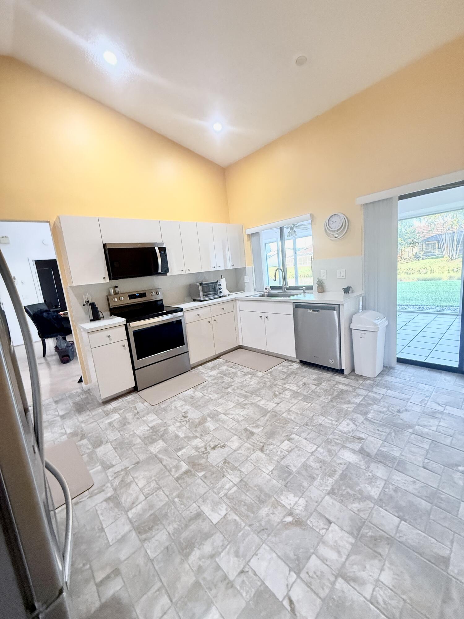 7024 Golf Pointe Circle Tamarac, FL 33321 - Photo 10 of 28 a large white bed in a white room