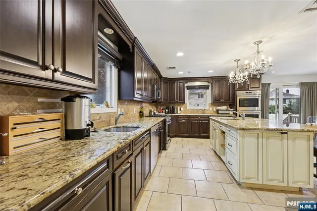 a kitchen with stainless steel appliances granite countertop a sink and cabinets