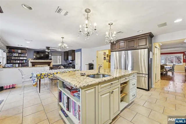 a kitchen with stainless steel appliances granite countertop a stove oven and a refrigerator