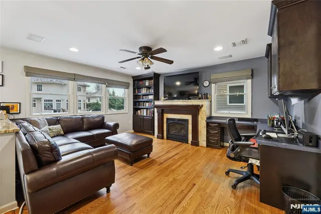 a living room with furniture a fireplace and a flat screen tv