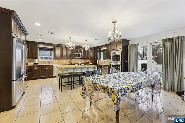 a living room with stainless steel appliances kitchen island granite countertop furniture and a kitchen view