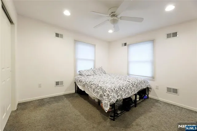 a spacious bedroom with a bed and a chandelier