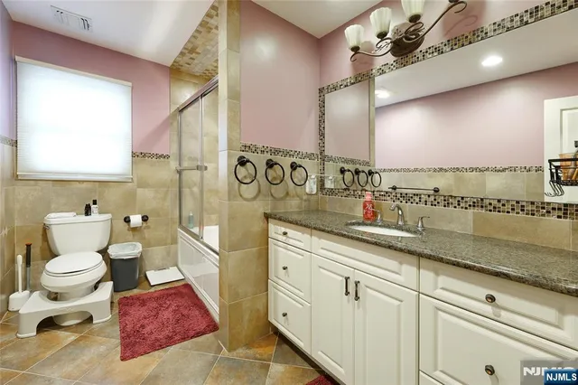 a spacious bathroom with a toilet sink and mirror