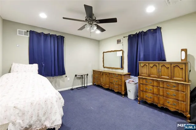 a bedroom with furniture and a flat screen tv