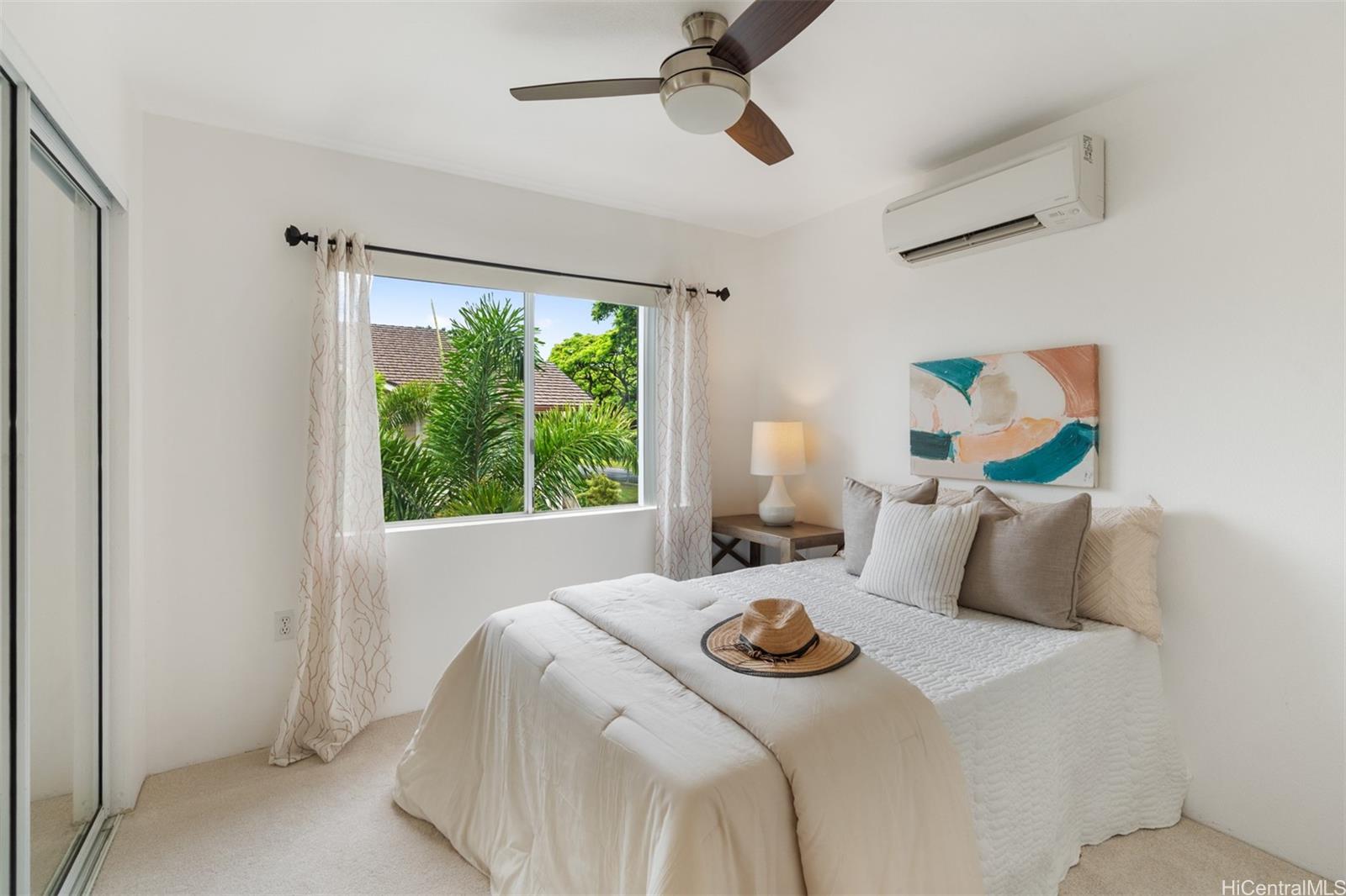 92-1487-a Aliinui Drive, Unit 27A Kapolei, HI 96707 - Photo 11 of 24 a bedroom with a bed and a window