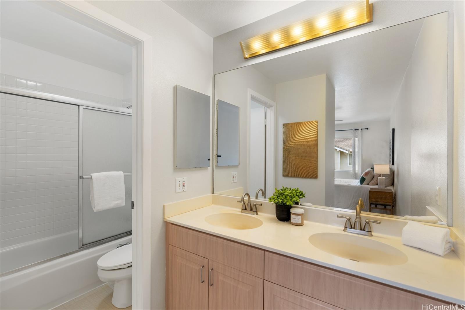 92-1487-a Aliinui Drive, Unit 27A Kapolei, HI 96707 - Photo 12 of 24 a bathroom with a double vanity sink toilet and shower