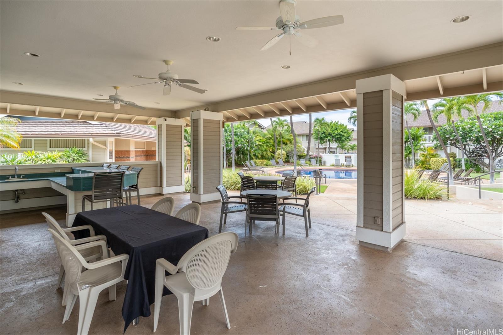 92-1487-a Aliinui Drive, Unit 27A Kapolei, HI 96707 - Photo 21 of 24 a dining room with furniture a chandelier and wooden floor