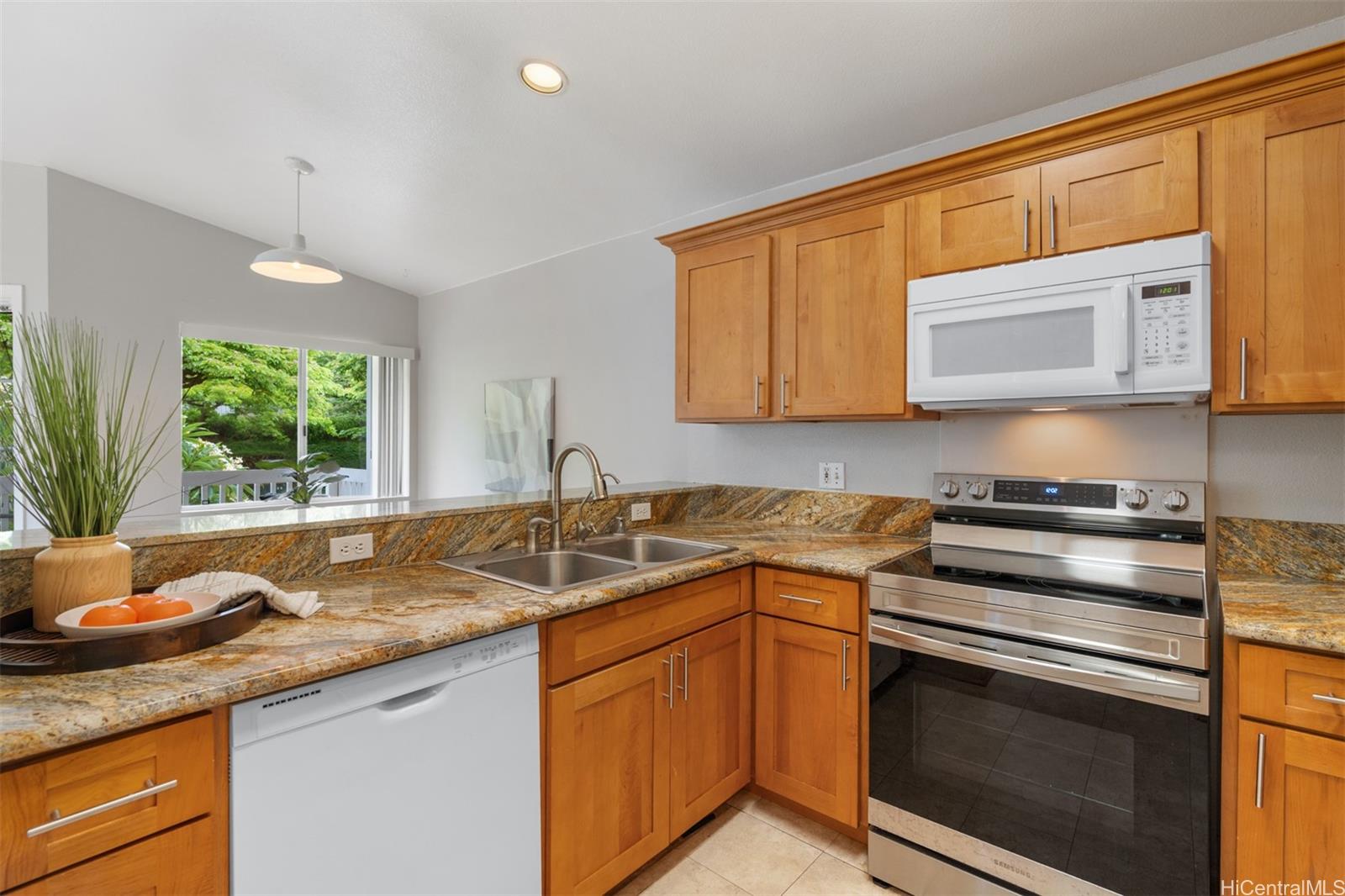 92-1487-a Aliinui Drive, Unit 27A Kapolei, HI 96707 - Photo 7 of 24 a kitchen with stainless steel appliances granite countertop a sink stove and microwave