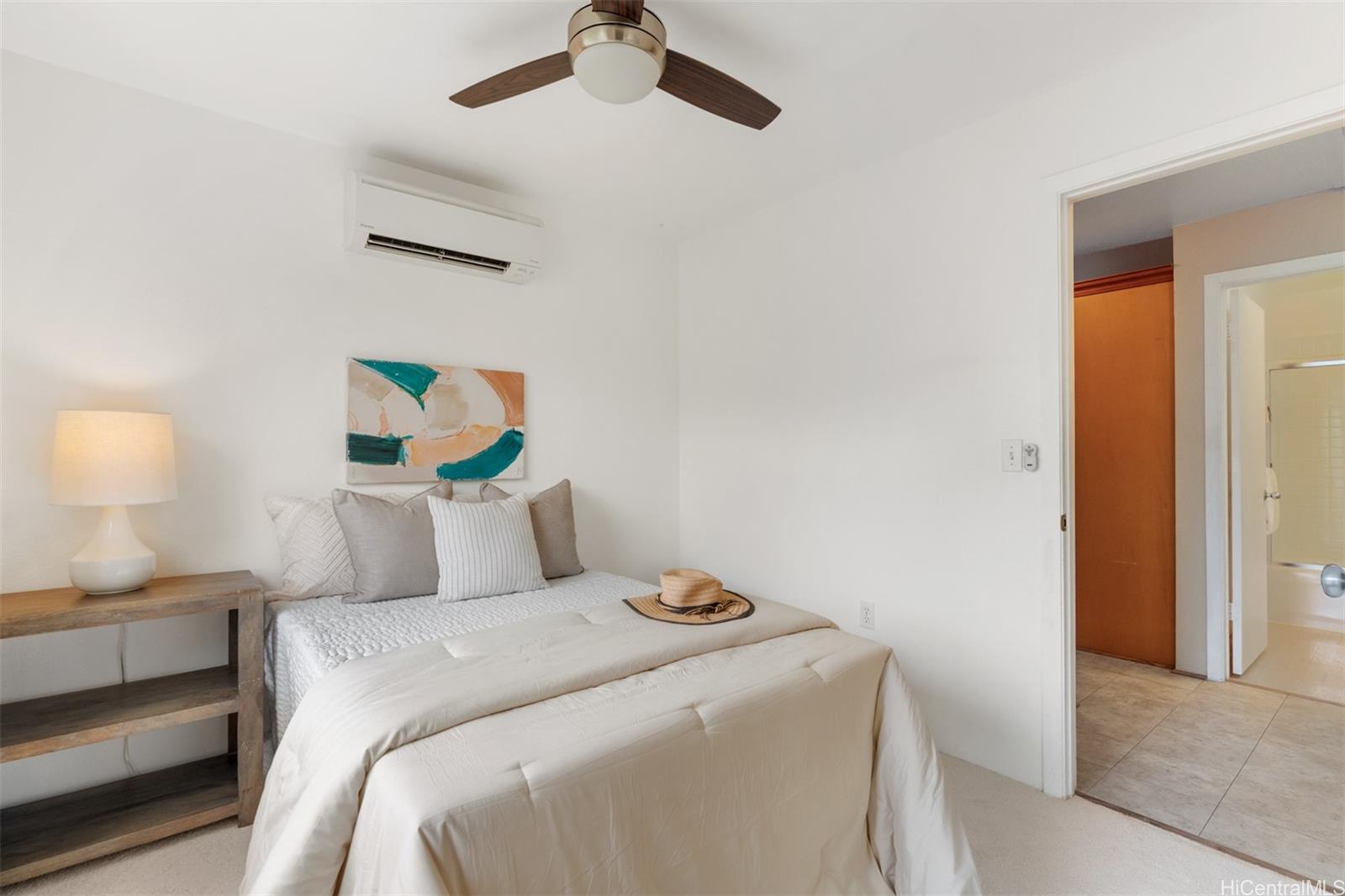 92-1487-a Aliinui Drive, Unit 27A Kapolei, HI 96707 - Photo 10 of 24 a bedroom with a bed and a lamp on the dresser