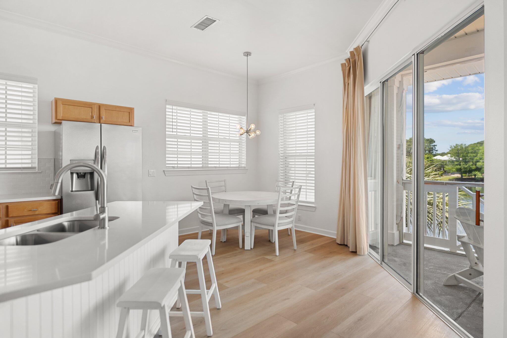 2221 Crystal Cove Lane, Unit 2221 Miramar Beach, FL 32550 - Photo 15 of 32 a dining room with wooden floor and a large window