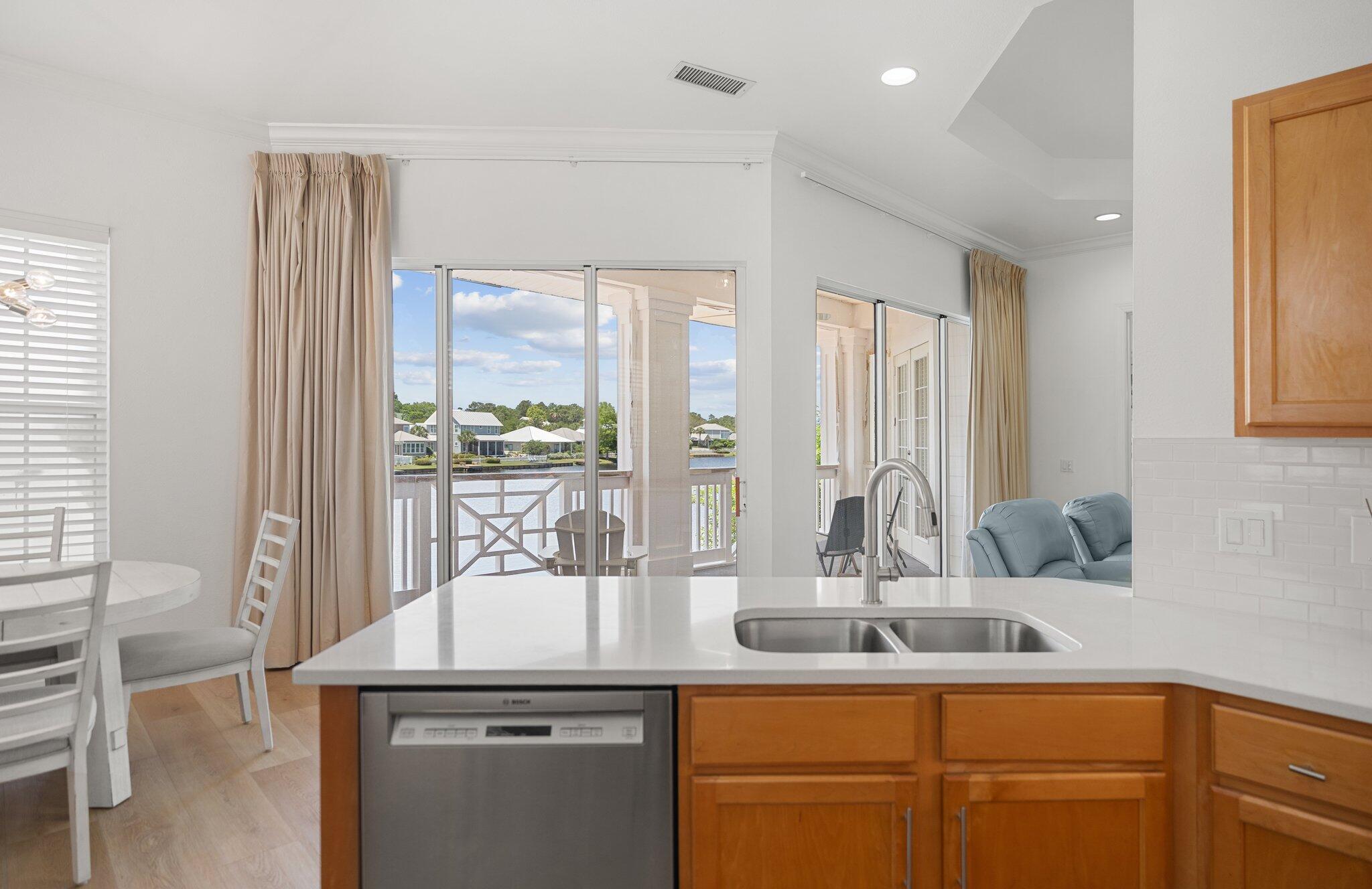 2221 Crystal Cove Lane, Unit 2221 Miramar Beach, FL 32550 - Photo 19 of 32 a kitchen with kitchen island granite countertop a sink and cabinets