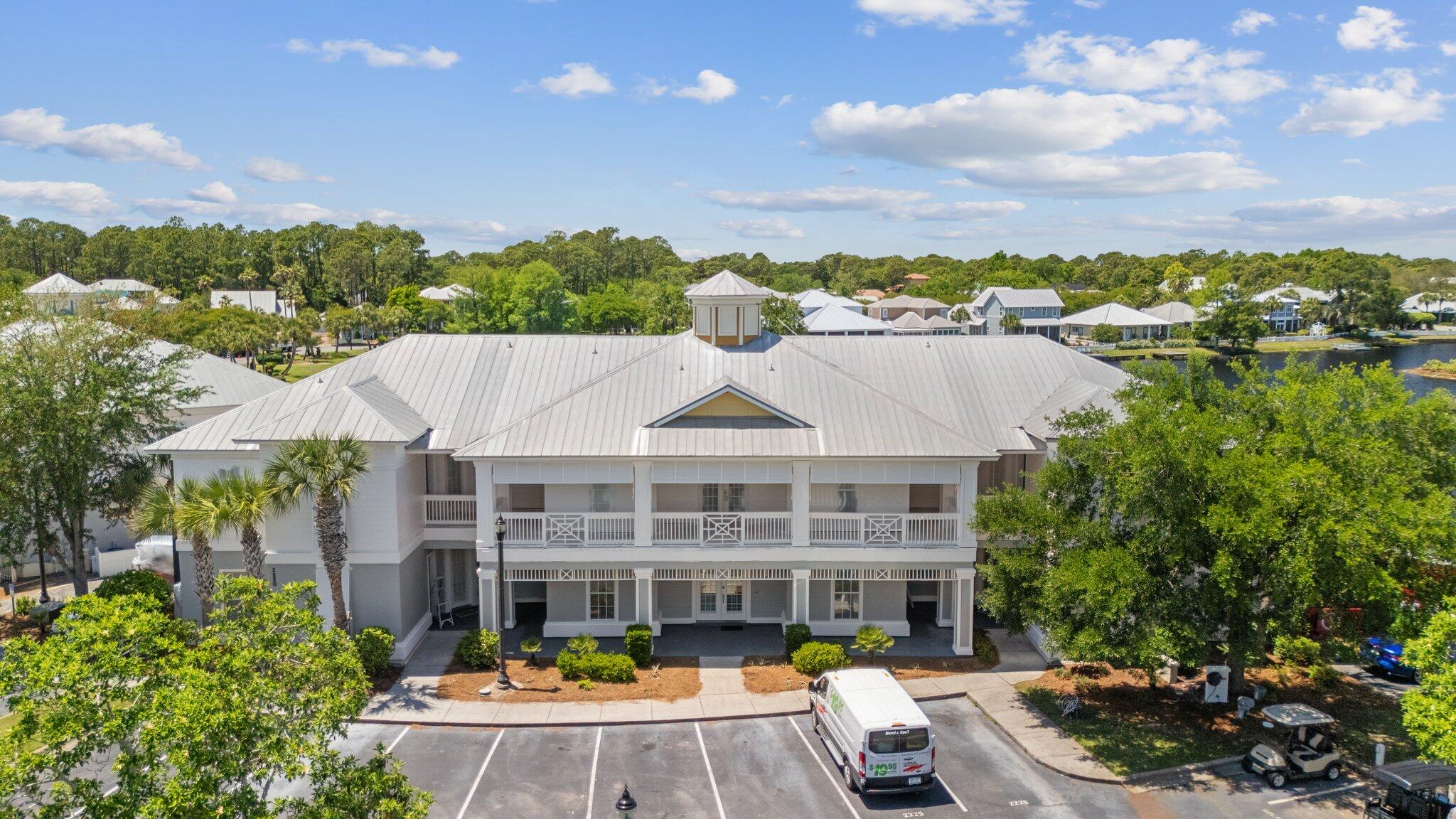 2221 Crystal Cove Lane, Unit 2221 Miramar Beach, FL 32550 - Photo 32 of 32 a front view of a house with swimming pool and outdoor seating