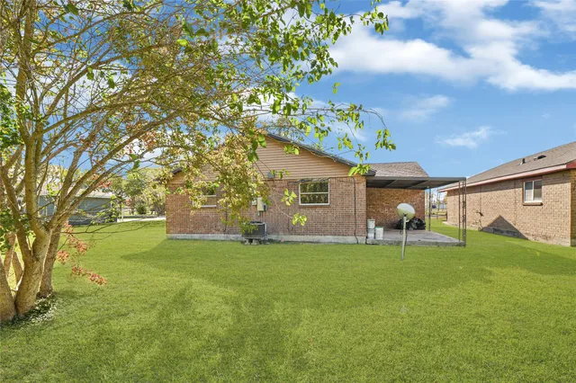 a backyard of a house with table and chairs