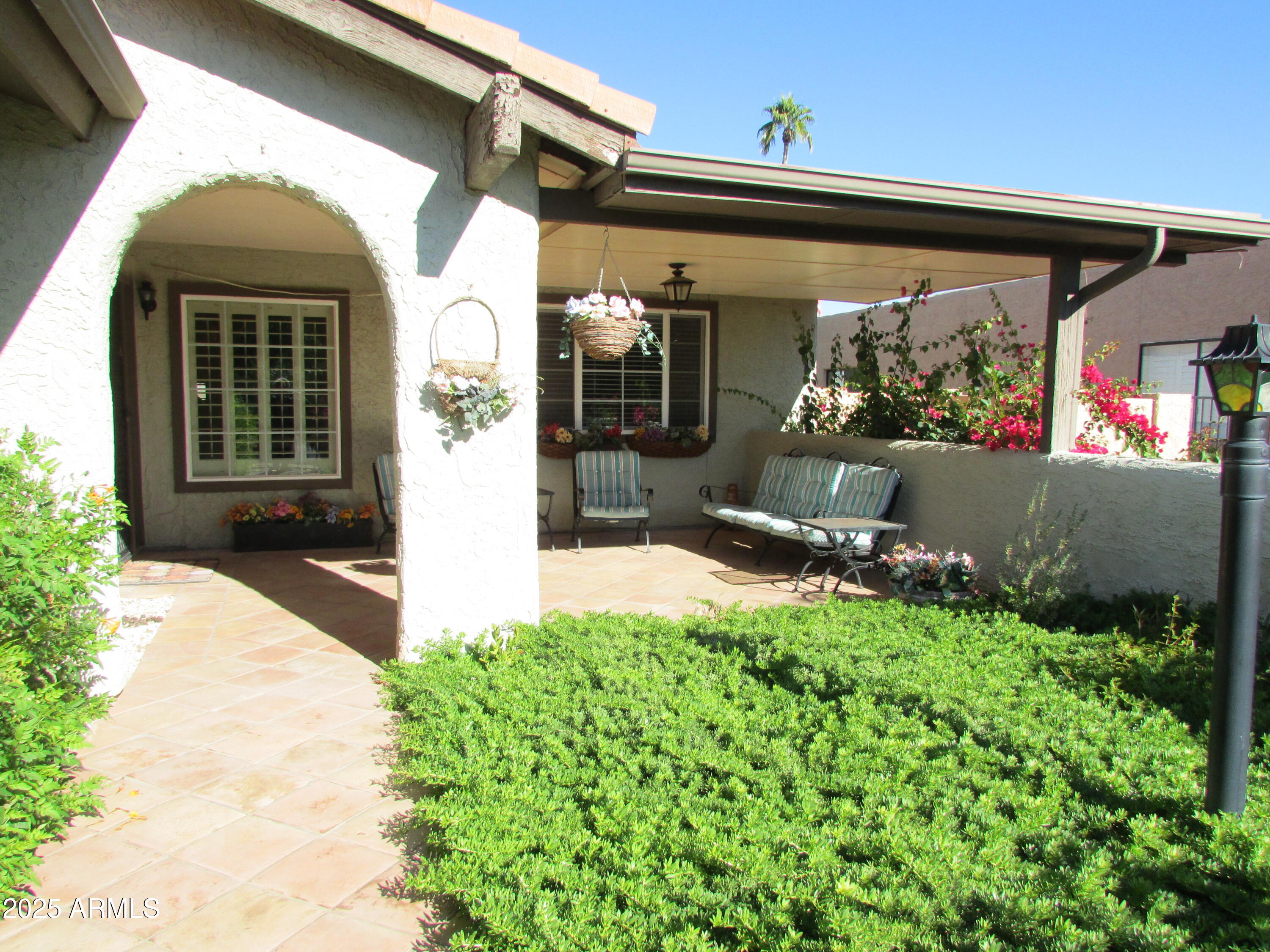 9438 East Michigan Avenue Sun Lakes, AZ 85248 - Photo 1 of 28 a front view of a house with garden