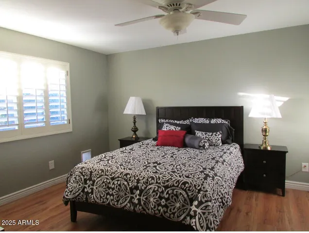 a bedroom with a bed and a lamp