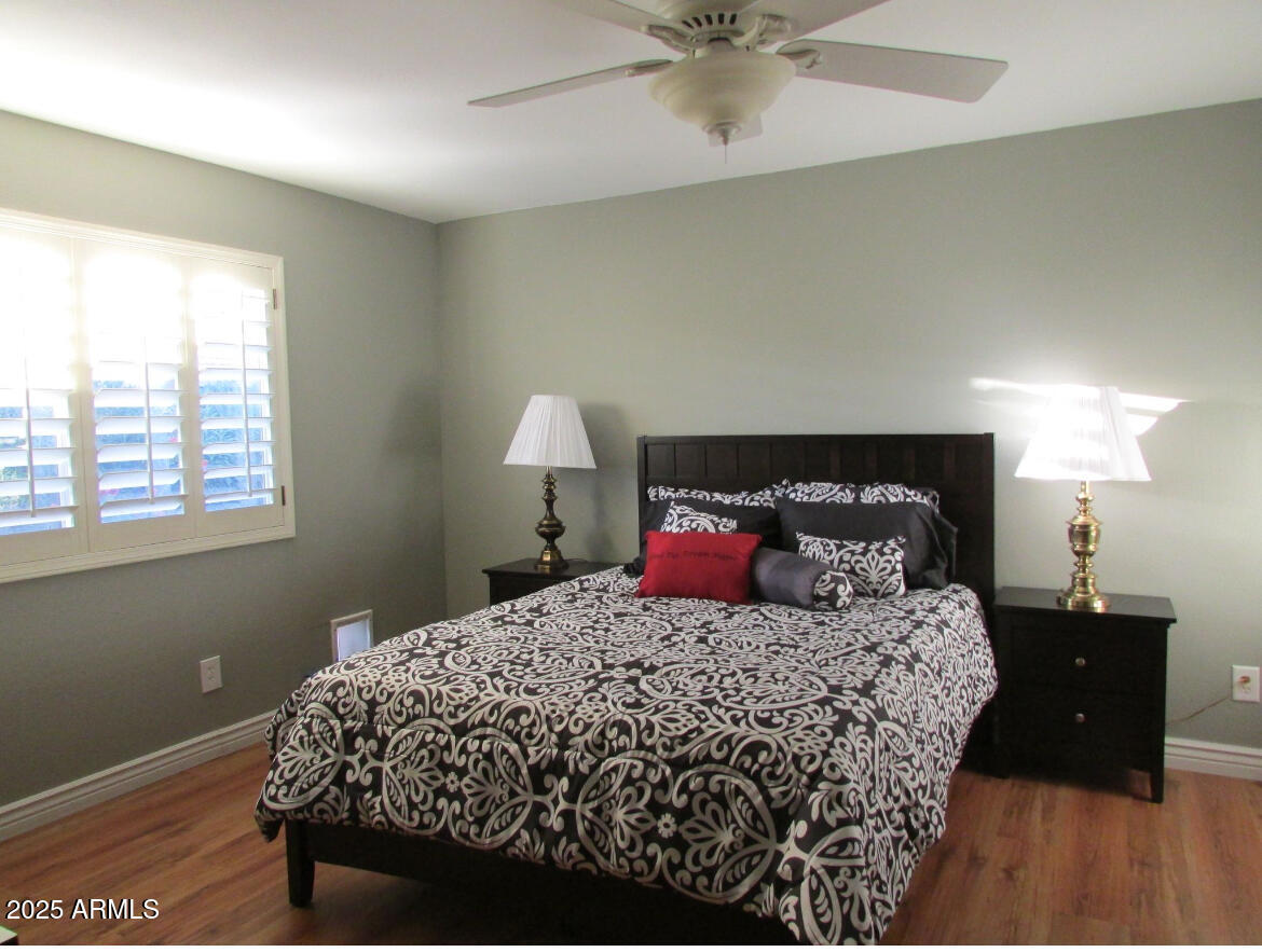 9438 East Michigan Avenue Sun Lakes, AZ 85248 - Photo 14 of 28 a bedroom with a bed and a lamp