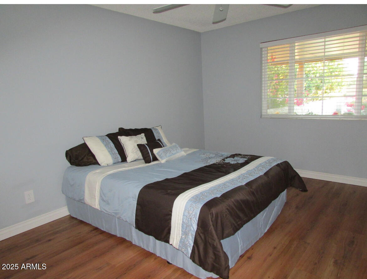 9438 East Michigan Avenue Sun Lakes, AZ 85248 - Photo 18 of 28 a bedroom with a bed and wooden floor