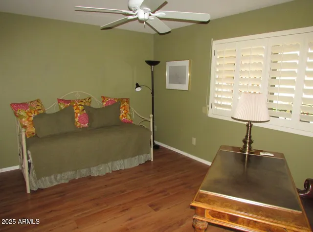 a living room with hard wood floors and a window