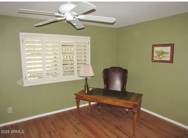 a view of a workspace with furniture and a window