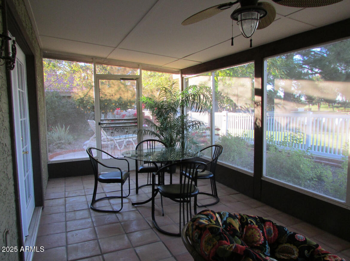 9438 East Michigan Avenue Sun Lakes, AZ 85248 - Photo 23 of 28 a dining room with furniture and a floor to ceiling window