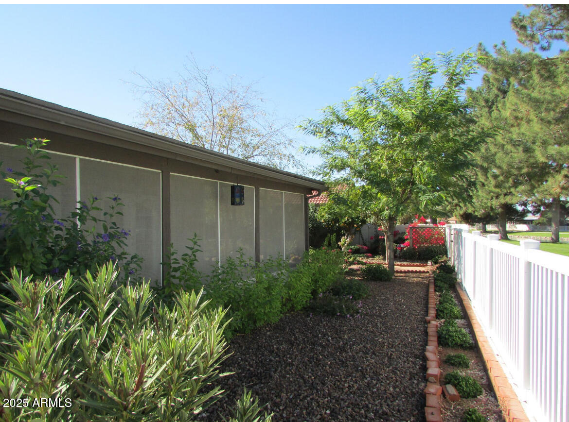 9438 East Michigan Avenue Sun Lakes, AZ 85248 - Photo 25 of 28 a view of a backyard with potted plants and large tree