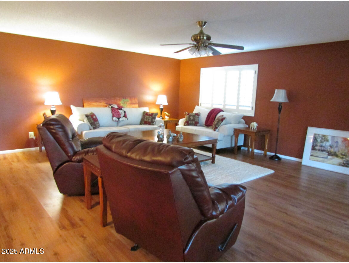 9438 East Michigan Avenue Sun Lakes, AZ 85248 - Photo 3 of 28 a living room with furniture and a wooden floor