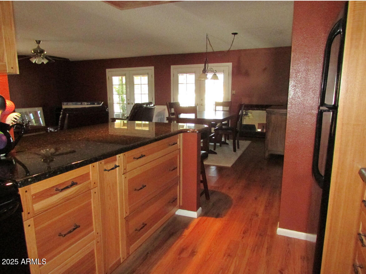 9438 East Michigan Avenue Sun Lakes, AZ 85248 - Photo 10 of 28 a kitchen with a sink dishwasher a dining table and chairs with wooden floor