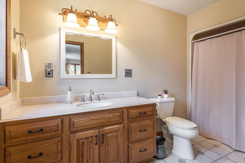 77 Richardson Road Boxborough, MA 01719 - Photo 17 of 32 a bathroom with a granite countertop toilet sink and a mirror