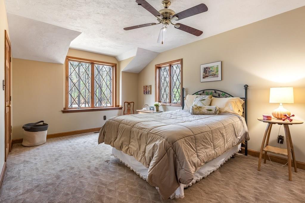 77 Richardson Road Boxborough, MA 01719 - Photo 18 of 32 a bedroom with a bed and a chandelier