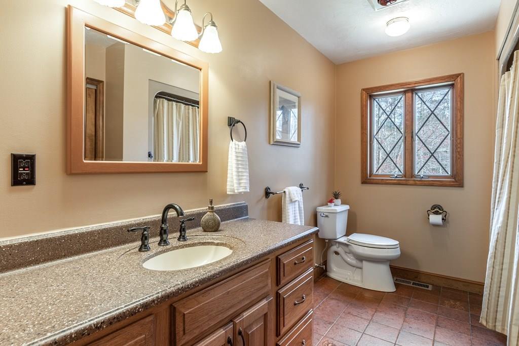 77 Richardson Road Boxborough, MA 01719 - Photo 20 of 32 a bathroom with a granite countertop toilet sink and mirror