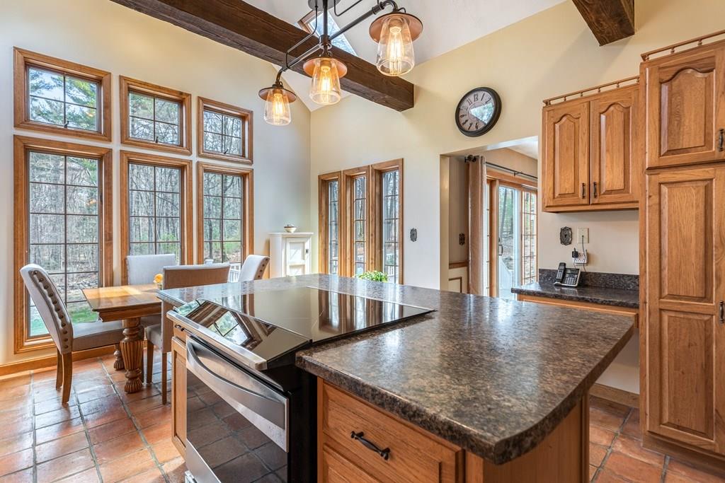 77 Richardson Road Boxborough, MA 01719 - Photo 3 of 32 a kitchen with granite countertop a table chairs a stove and a dining table view