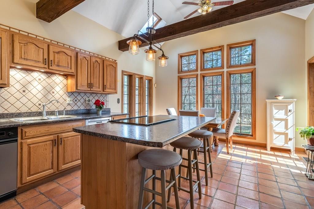77 Richardson Road Boxborough, MA 01719 - Photo 4 of 32 a dining table with chairs and cabinets