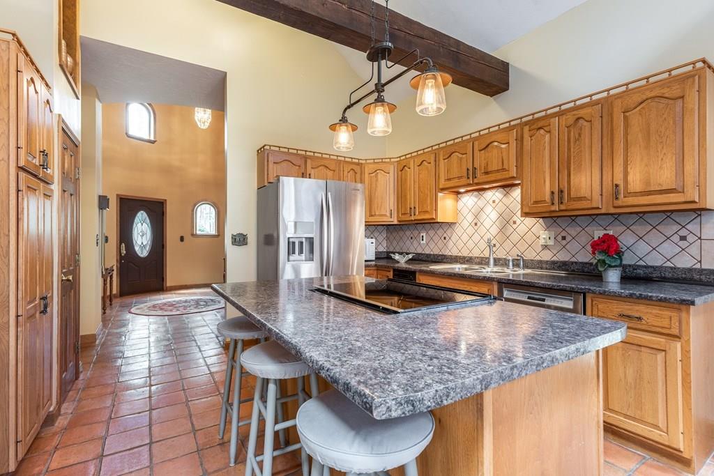 77 Richardson Road Boxborough, MA 01719 - Photo 7 of 32 a kitchen with granite countertop a table chairs window and refrigerator