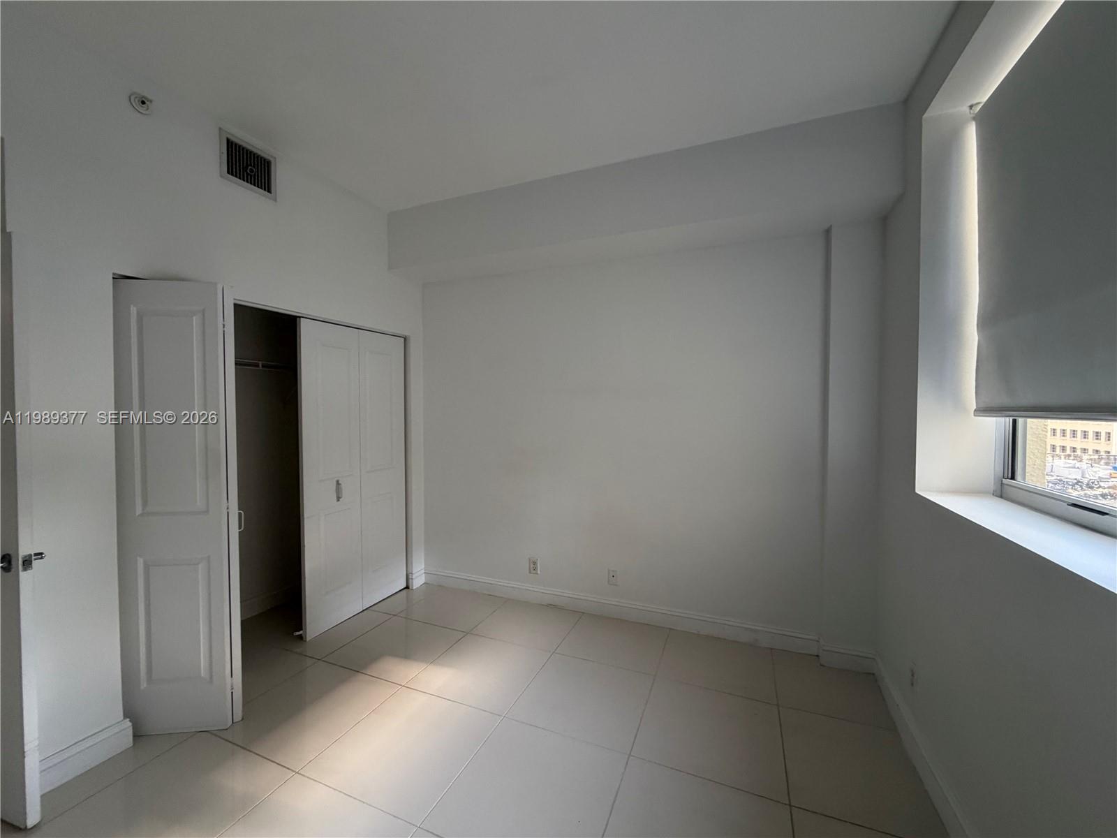 111 East Flagler Street, Unit 606 Miami, FL 33131 - Photo 6 of 10 an empty room with a bathroom