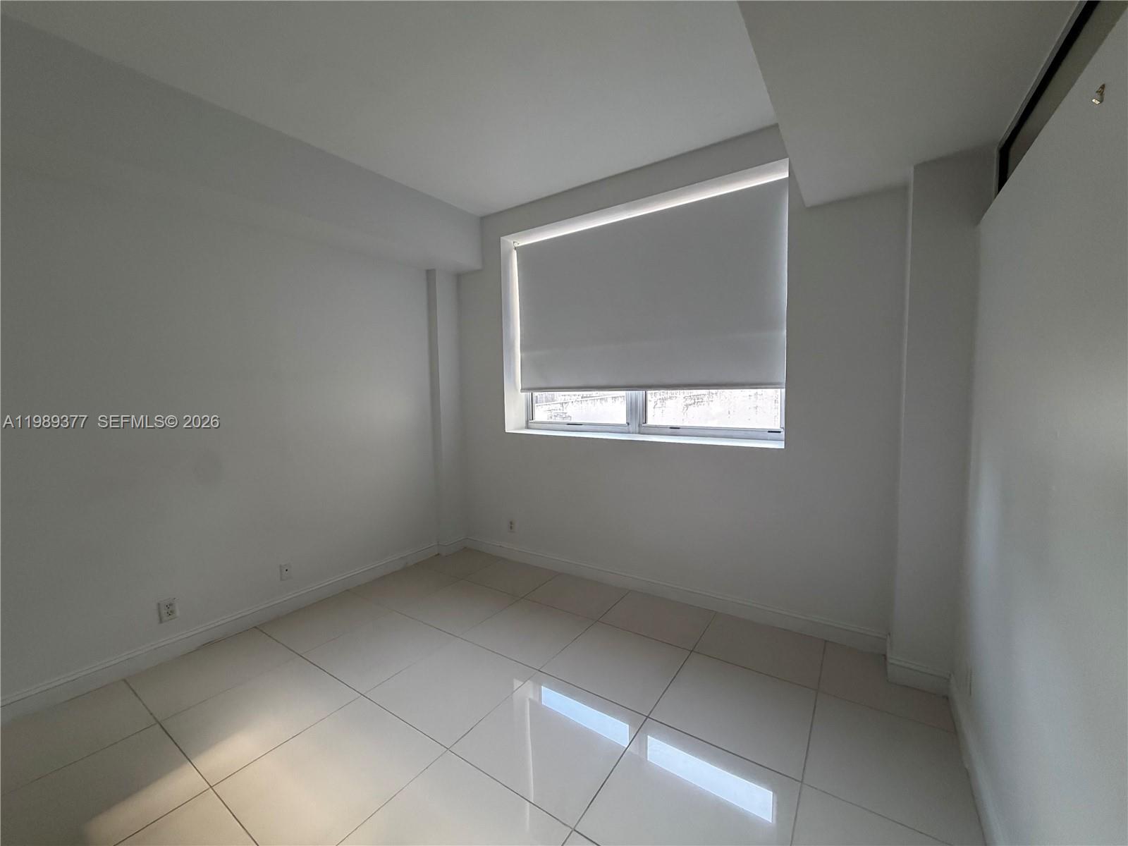 111 East Flagler Street, Unit 606 Miami, FL 33131 - Photo 7 of 10 a view of an empty room with a window