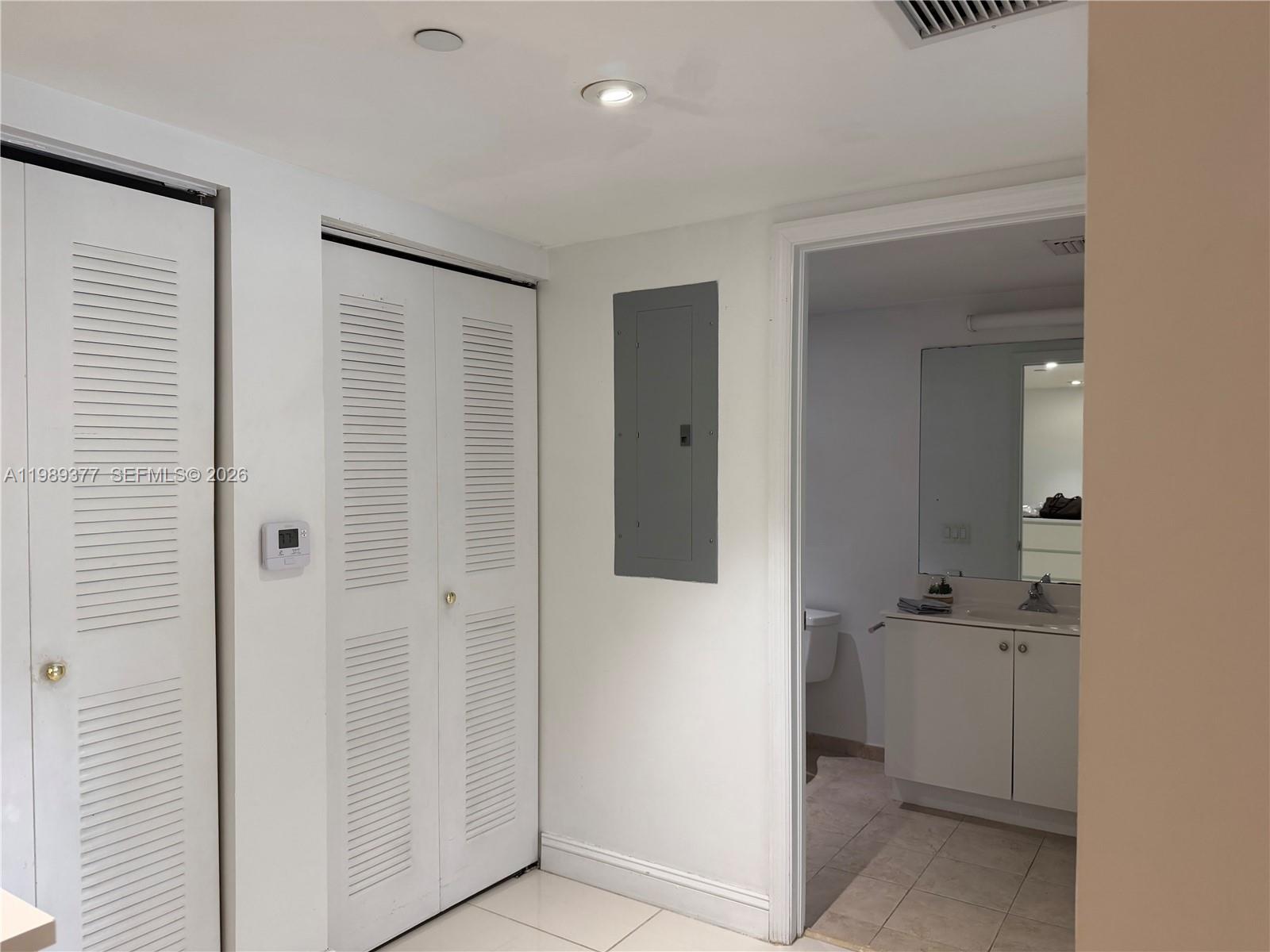 111 East Flagler Street, Unit 606 Miami, FL 33131 - Photo 10 of 10 a bathroom with a sink and mirror