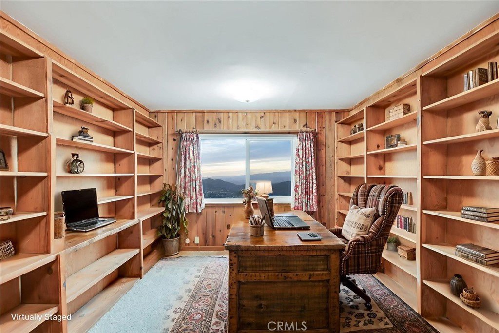 6750 Rainbow Heights Road Fallbrook, CA 92028 - Photo 24 of 64 a living room with furniture a rug and a book shelf