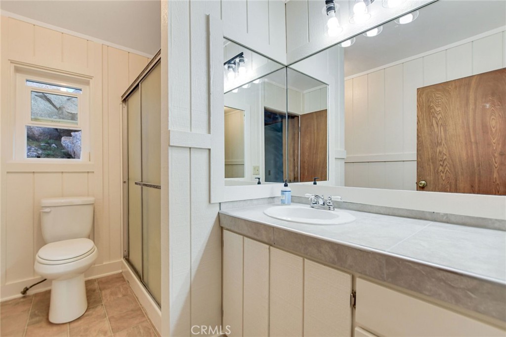 6750 Rainbow Heights Road Fallbrook, CA 92028 - Photo 26 of 64 a bathroom with a granite countertop sink a toilet and a large mirror