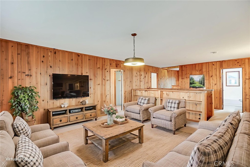 6750 Rainbow Heights Road Fallbrook, CA 92028 - Photo 27 of 64 a living room with furniture a flat screen tv and a large window