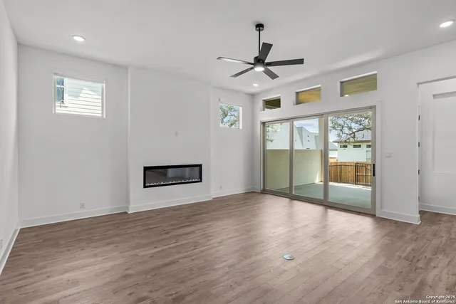 a view of kitchen with refrigerator and wooden floor