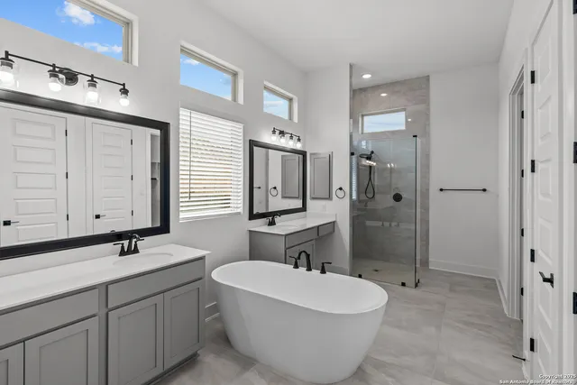 a bathroom with a tub sink and mirror