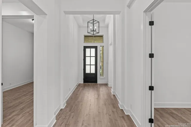 a view of an entryway with wooden floor
